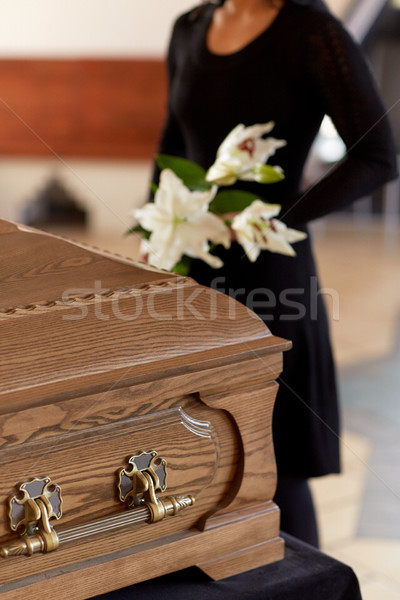woman with flowers and coffin at funeral Stock photo © dolgachov