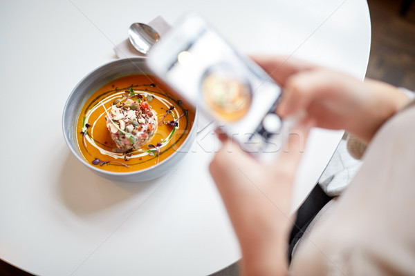Stock photo: woman with smartphone photographing food at cafe