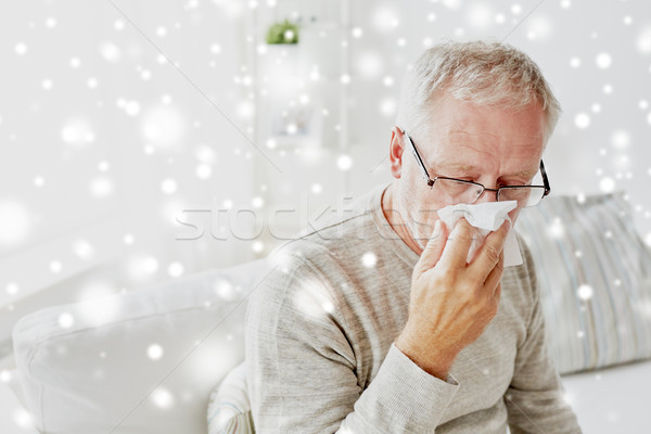 sick senior man with paper wipe blowing his nose Stock photo © dolgachov
