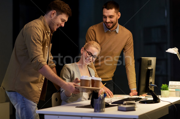Stock photo: business team with computer working late at office