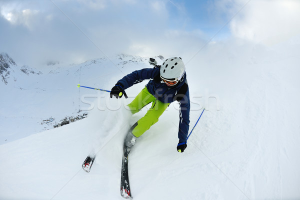 skiing on fresh snow at winter season at beautiful sunny day Stock photo © dotshock