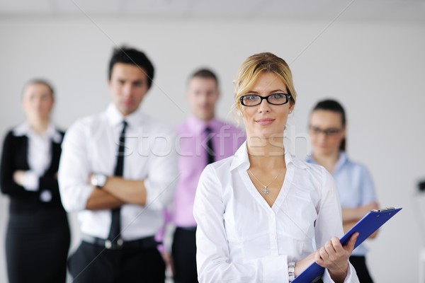 Stock photo: business woman standing with her staff in background