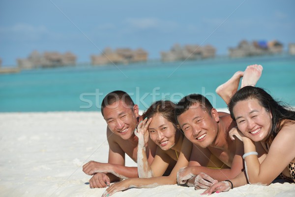 group of happy young people have fun on bach Stock photo © dotshock