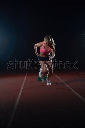 Athletic woman running on track Stock photo © dotshock