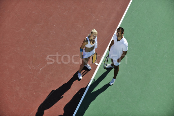 happy young couple play tennis game outdoor Stock photo © dotshock