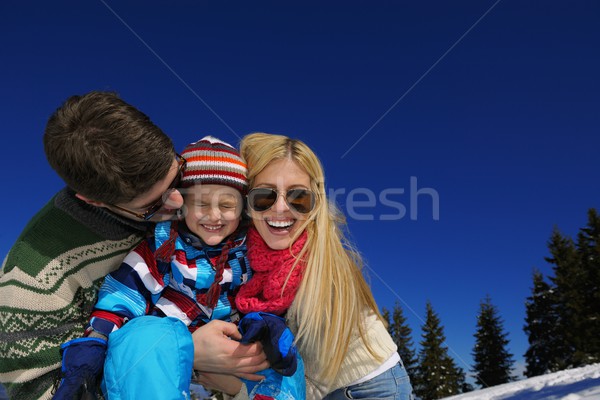 family having fun on fresh snow at winter vacation Stock photo © dotshock