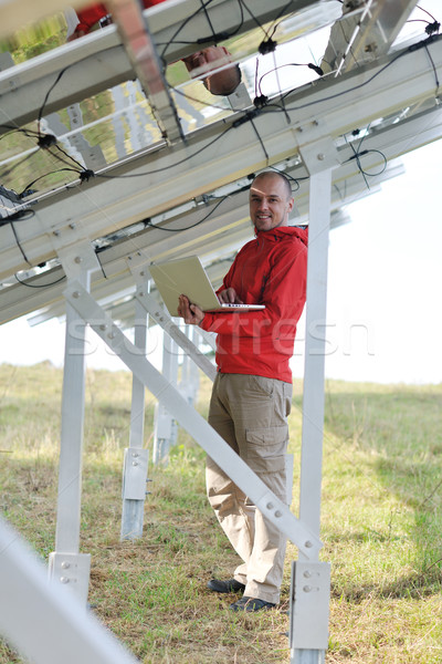 engineer using laptop at solar panels plant field Stock photo © dotshock
