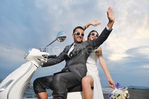 just married couple on the beach ride white scooter Stock photo © dotshock