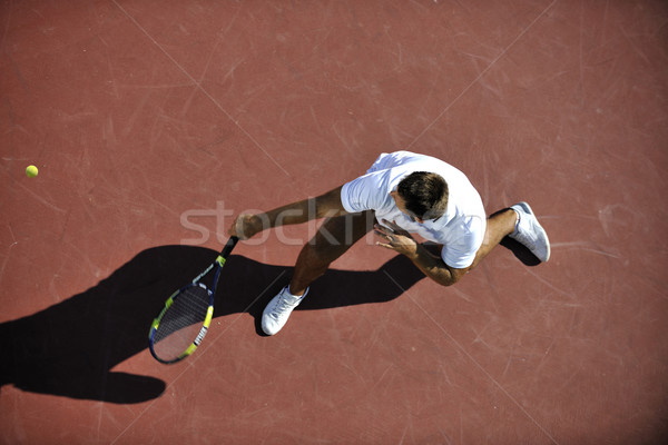Fiatalember játék tenisz szabadtér narancs mező Stock fotó © dotshock
