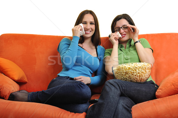 Femenino amigos comer palomitas viendo tv Foto stock © dotshock