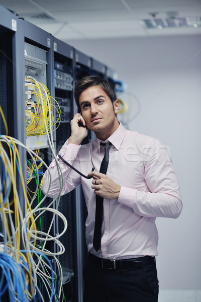 Stock photo: it engeneer talking by phone at network room