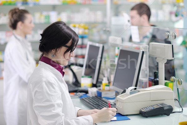 Stock photo: pharmacist suggesting medical drug to buyer in pharmacy drugstore