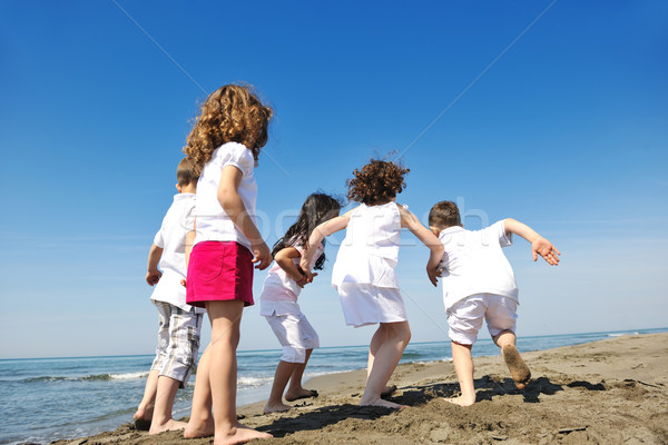 Stock photo: happy child group playing  on beach