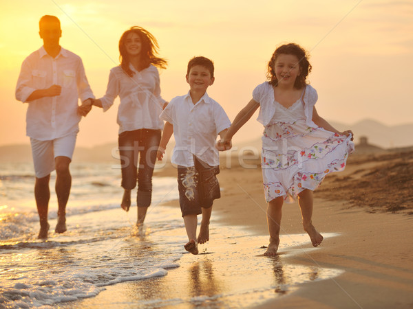 Stock photo: happy young family have fun on beach at sunset