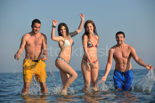 happy people group have fun and running on beach Stock photo © dotshock