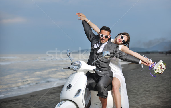 just married couple on the beach ride white scooter Stock photo © dotshock