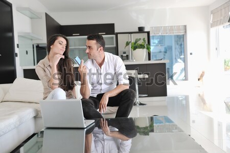 Alegre casal relaxar trabalhar computador portátil moderno Foto stock © dotshock