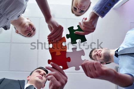 Stock photo: Group of business people assembling jigsaw puzzle