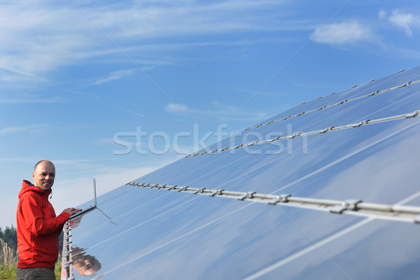 engineer using laptop at solar panels plant field Stock photo © dotshock