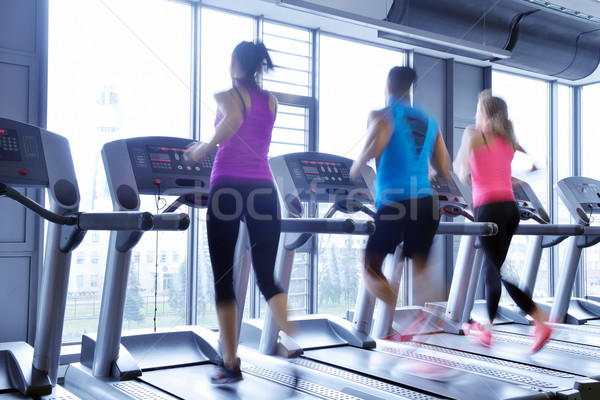 Group of people running on treadmills Stock photo © dotshock