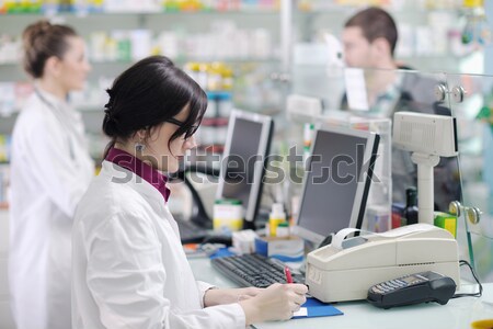 pharmacist suggesting medical drug to buyer in pharmacy drugstore Stock photo © dotshock