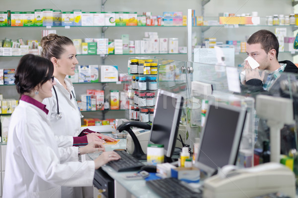 pharmacist suggesting medical drug to buyer in pharmacy drugstore Stock photo © dotshock