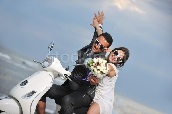 just married couple on the beach ride white scooter Stock photo © dotshock