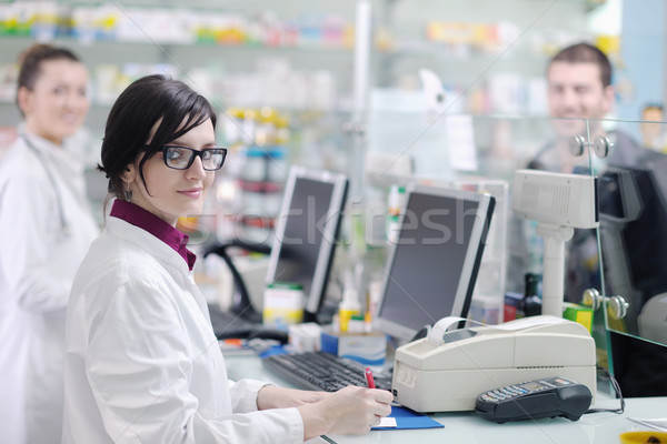 Stock photo: pharmacist suggesting medical drug to buyer in pharmacy drugstore