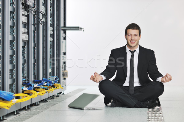 Stock photo: business man practice yoga at network server room