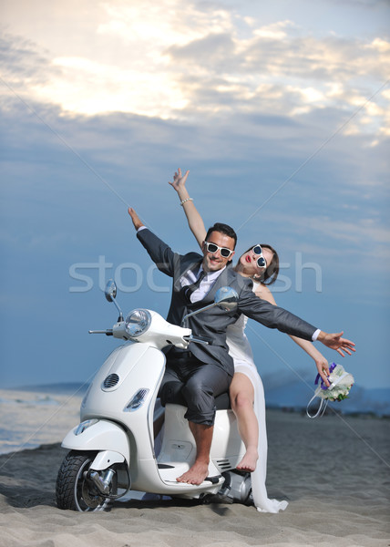 just married couple on the beach ride white scooter Stock photo © dotshock