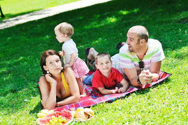 Stock photo: happy young couple with their children have fun at park