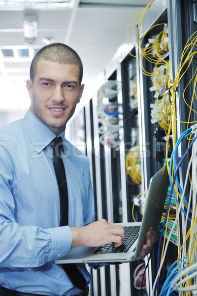 businessman with laptop in network server room Stock photo © dotshock
