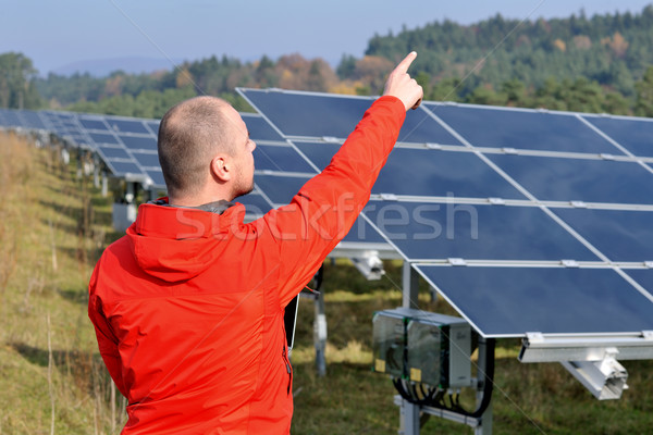 Stock photo: engineer using laptop at solar panels plant field
