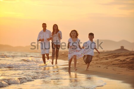 Mutlu genç aile eğlence plaj gün batımı Stok fotoğraf © dotshock