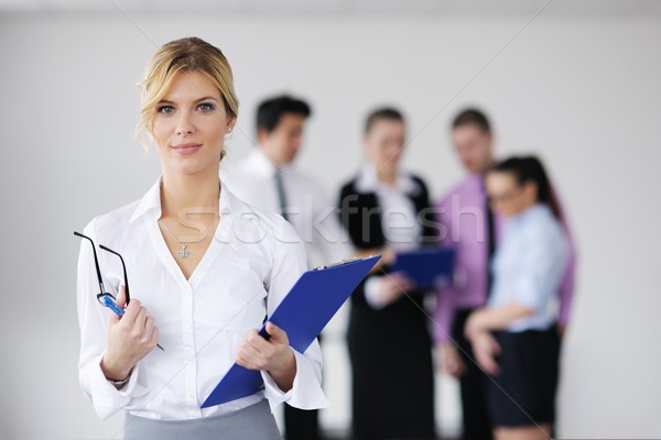 Stock photo: business woman standing with her staff in background