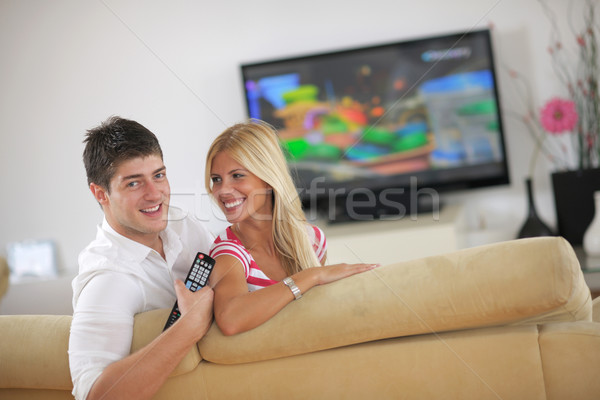Relaxed young  couple watching tv at home Stock photo © dotshock