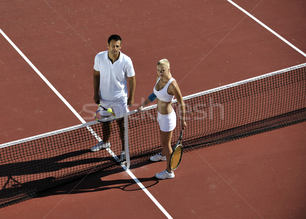 happy young couple play tennis game outdoor Stock photo © dotshock