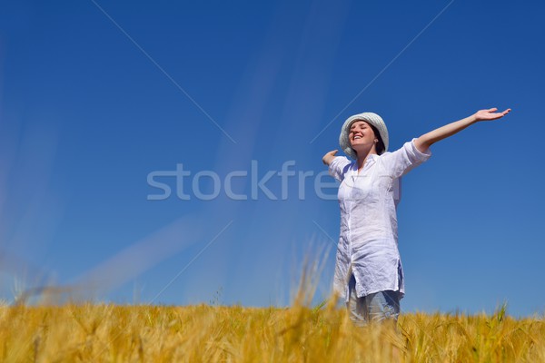 young woman with spreading arms to sky Stock photo © dotshock