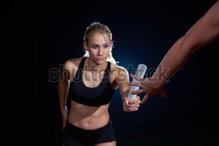 athletic runners passing baton in relay race Stock photo © dotshock