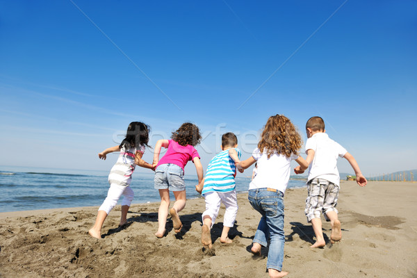 Stock photo: happy child group playing  on beach