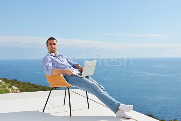 Entspannt junger Mann home Balkon gut aussehend entspannenden Stock foto © dotshock