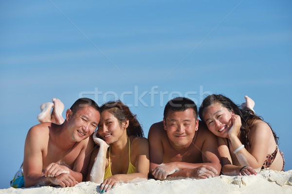group of happy young people have fun on bach Stock photo © dotshock