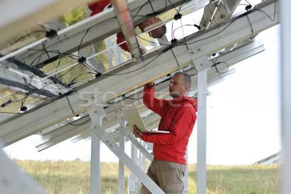 engineer using laptop at solar panels plant field Stock photo © dotshock