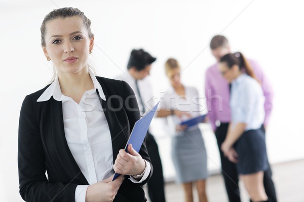 business woman standing with her staff in background Stock photo © dotshock