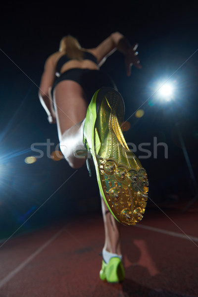 woman  sprinter leaving starting blocks Stock photo © dotshock