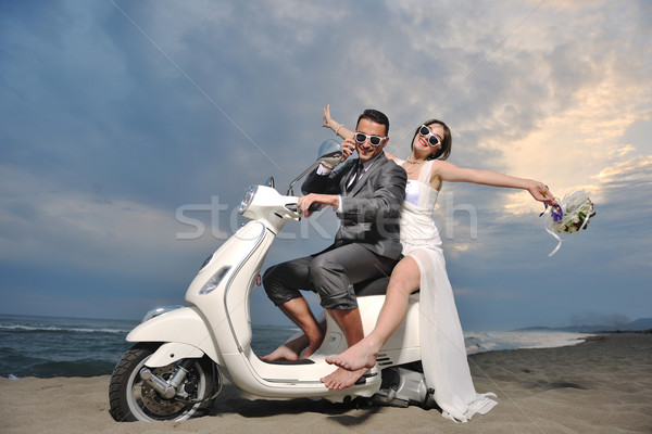 Friss házasok pár tengerpart fehér moped esküvő Stock fotó © dotshock