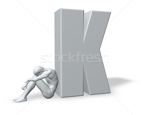sitting man leans on uppercase letter k Stock photo © drizzd
