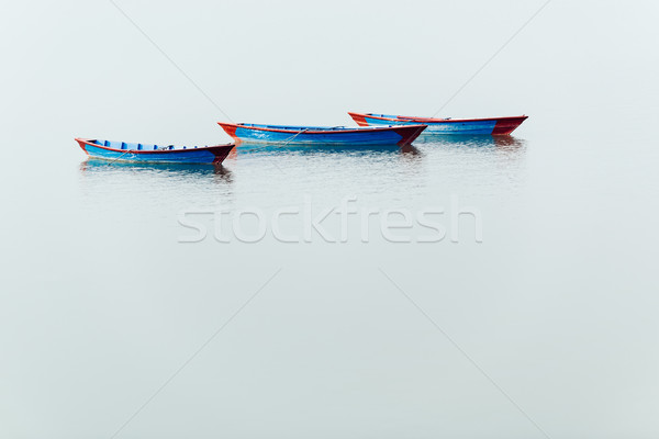 Three blue boats on Phewa Lake in Pokhara Stock photo © dutourdumonde