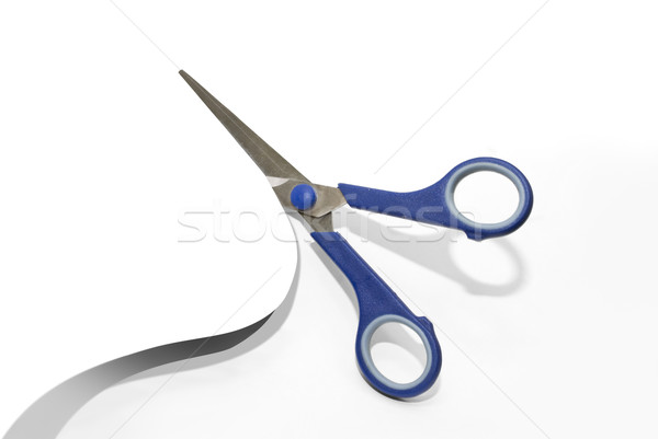 Stock photo: Scissors cutting a paper