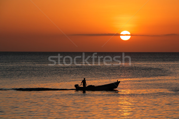 Boat silhouetted against sunset Stock photo © EcoPic